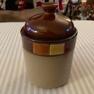 The Casa Estebana Canister is made of stoneware with reactive glazes.